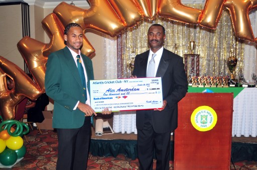 Alex Amsterdam (left) accepts his scholarship check for $1,000. from Atlantis president Steve Welcome
