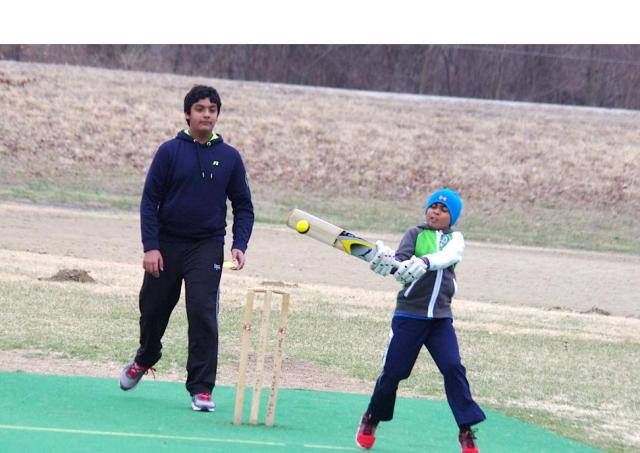 Youth Cricketer on Tip-Toes as he play a short delivery